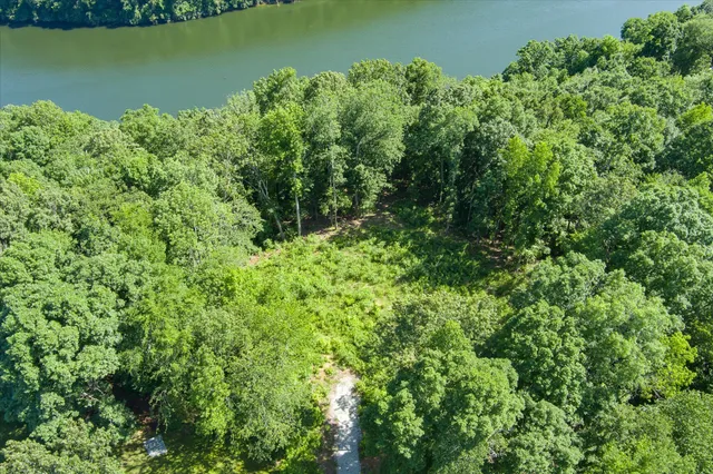 an aerial view of a houses with a yard
