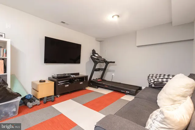 a bedroom with bed and a flat screen tv
