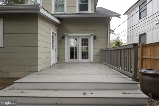 a view of entrance gate of house and car parked