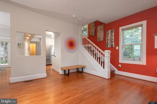 a view of an entryway with wooden floor and windows
