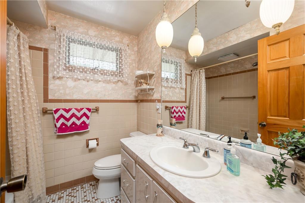 109 Hillcrest Road Renfrew, PA 16053 - Photo 15 of 30 a bathroom with a sink a mirror and a toilet