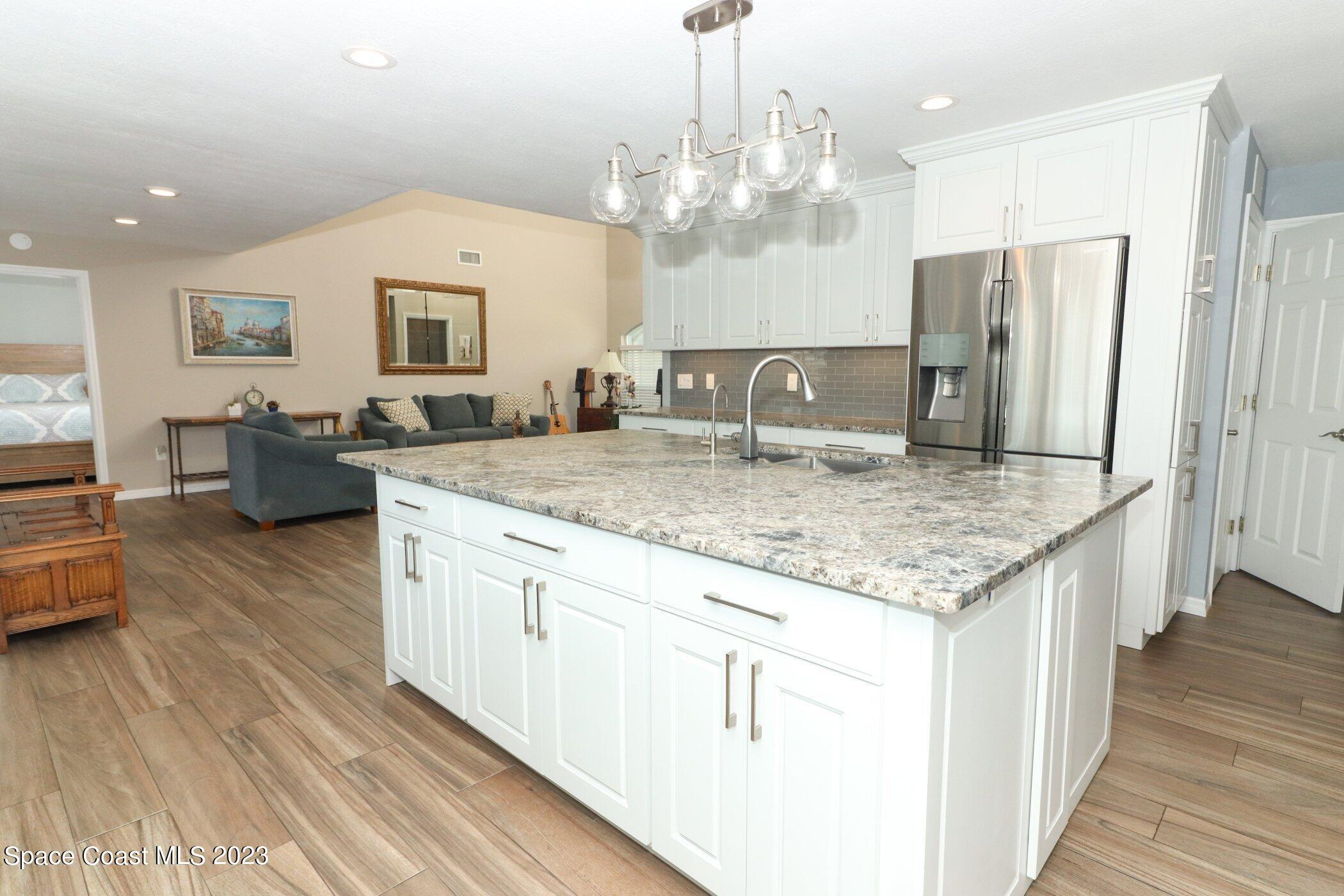 834 Egret Road Cocoa, FL 32926 - Photo 13 of 85 a kitchen with stainless steel appliances granite countertop a stove refrigerator and cabinets