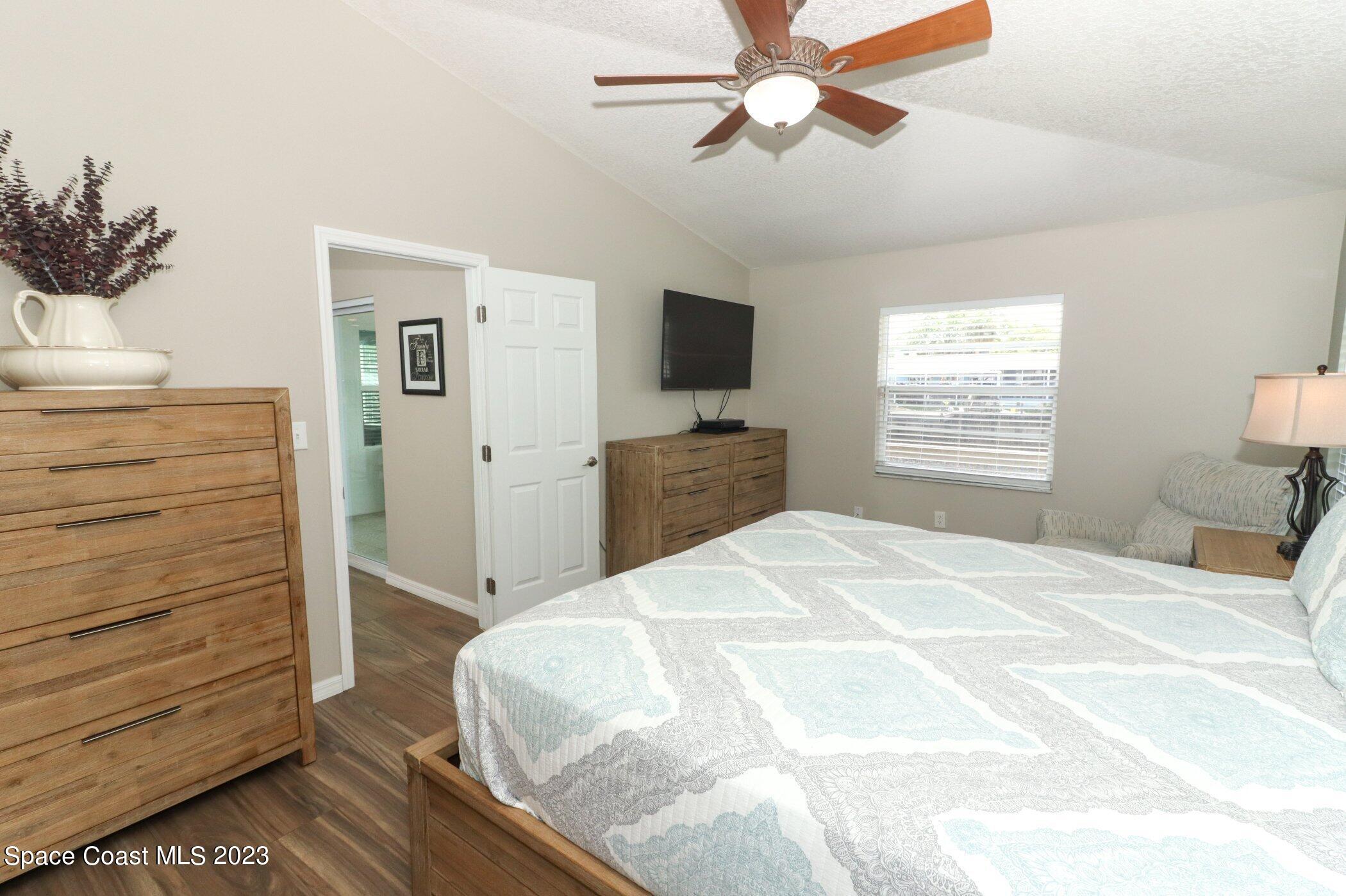 834 Egret Road Cocoa, FL 32926 - Photo 17 of 85 a bedroom with a bed and a flat screen tv