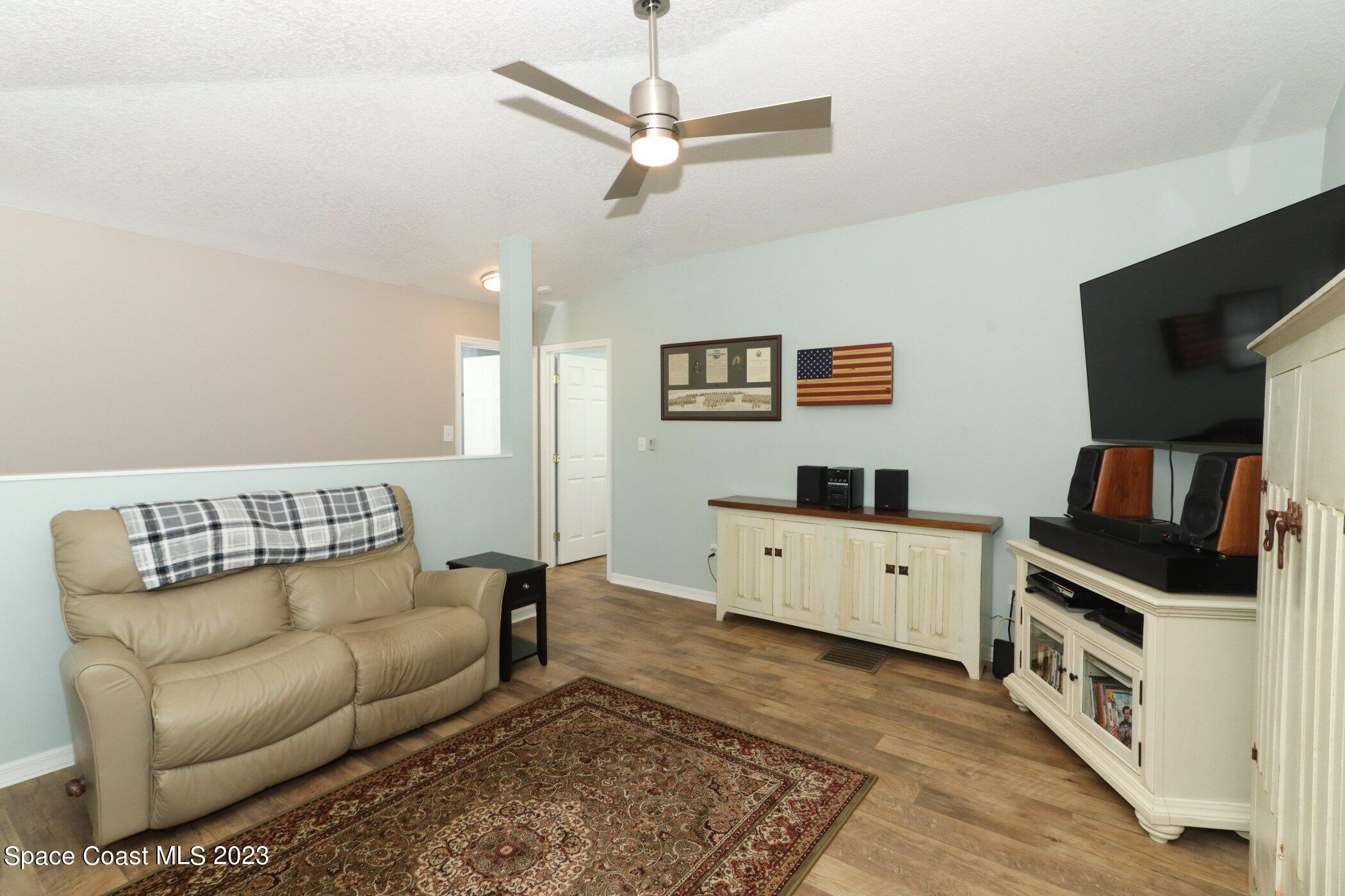 834 Egret Road Cocoa, FL 32926 - Photo 24 of 85 a living room with furniture and a flat screen tv