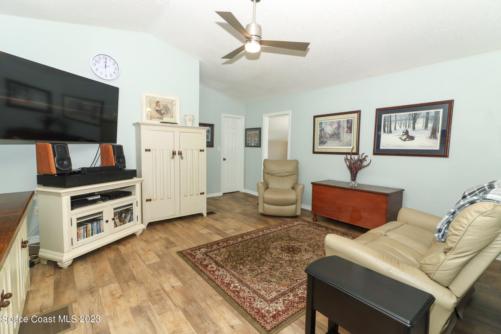 834 Egret Road Cocoa, FL 32926 - Photo 26 of 85 a living room with furniture and a flat screen tv