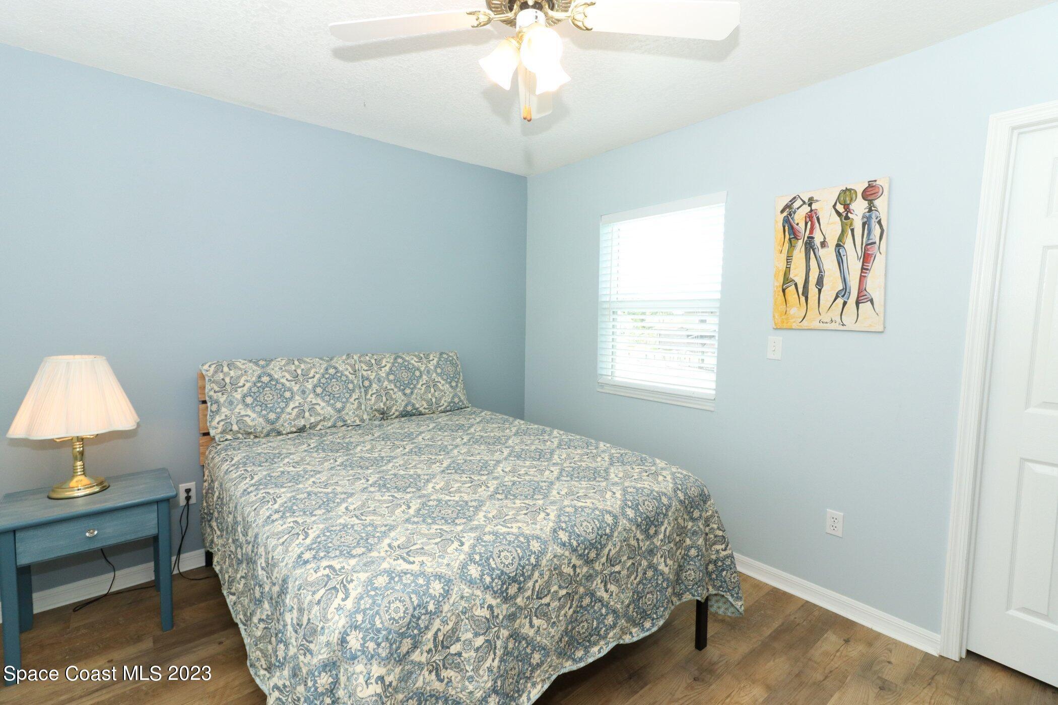 834 Egret Road Cocoa, FL 32926 - Photo 29 of 85 a large bed sitting in a bedroom next to a window