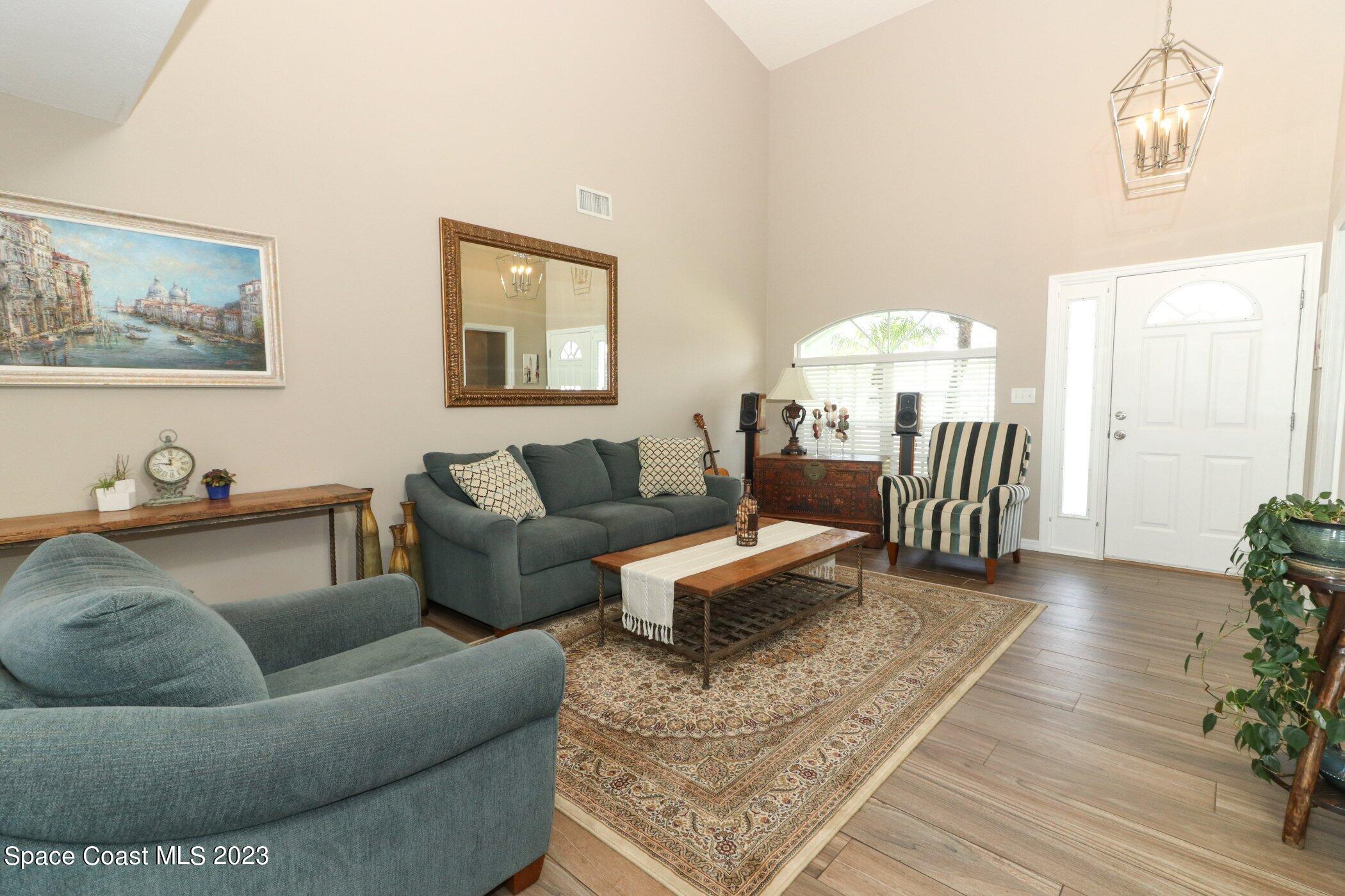 834 Egret Road Cocoa, FL 32926 - Photo 3 of 85 a living room with furniture and a chandelier