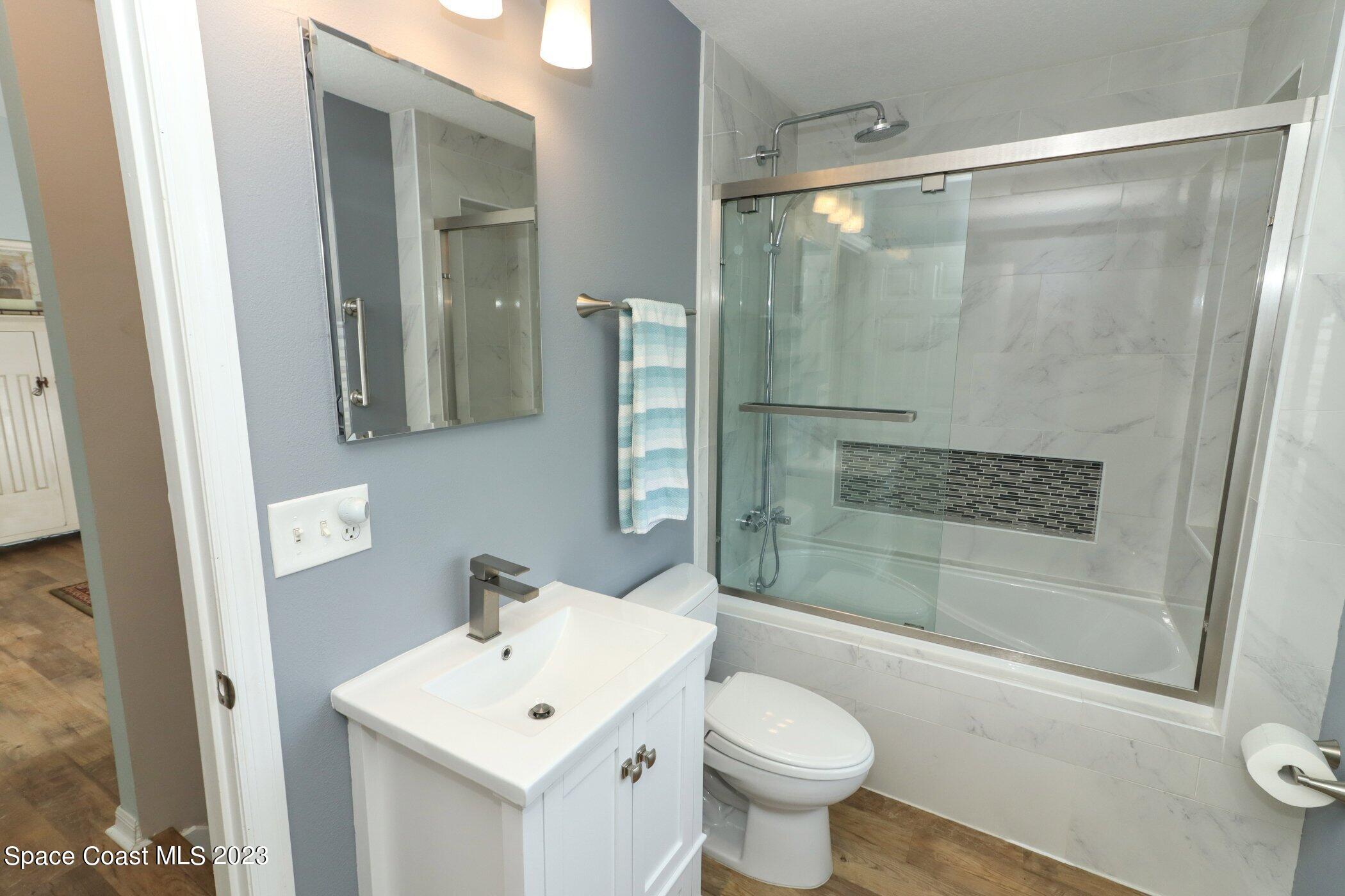 834 Egret Road Cocoa, FL 32926 - Photo 31 of 85 a bathroom with a sink mirror toilet and shower