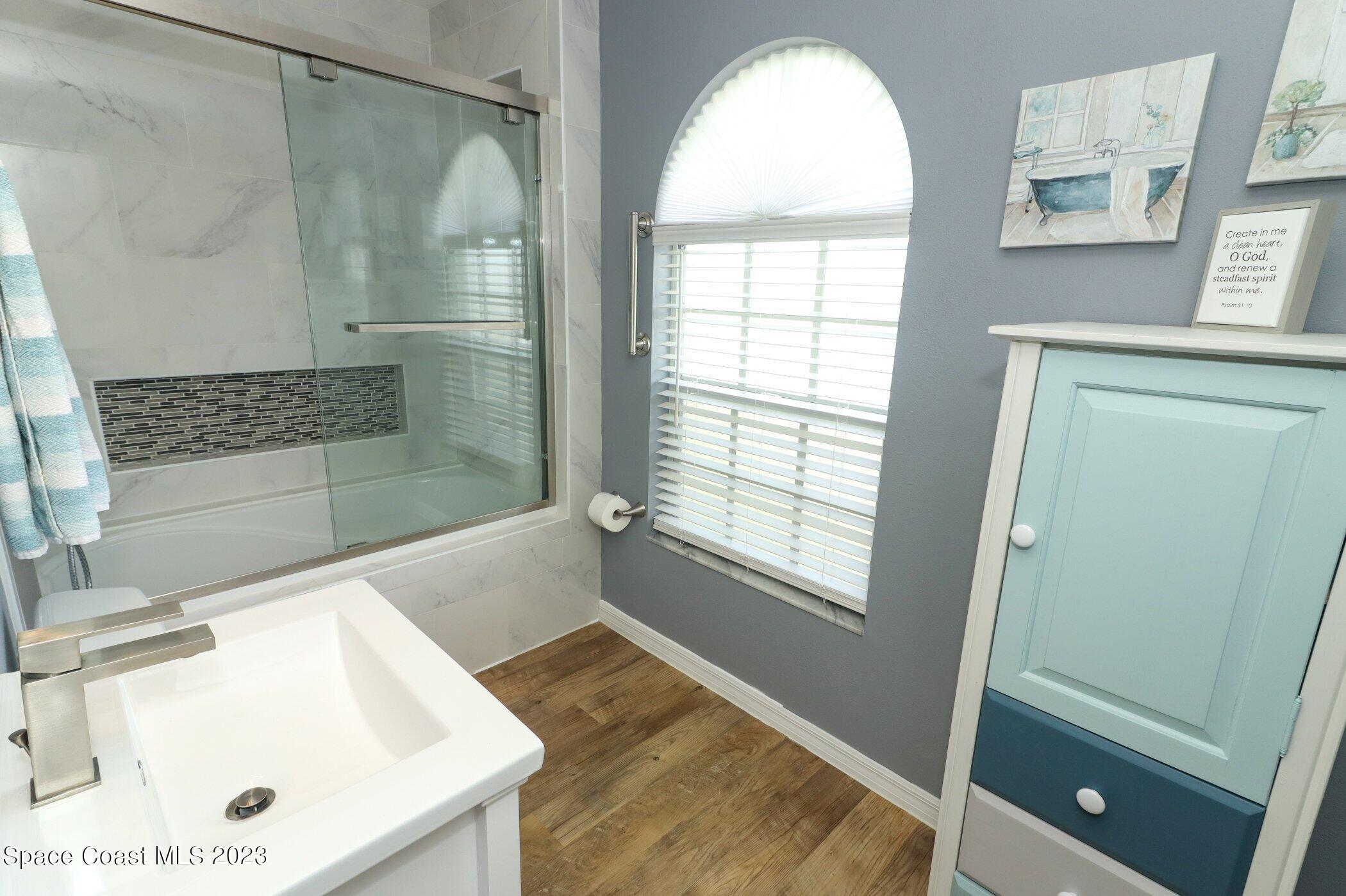 834 Egret Road Cocoa, FL 32926 - Photo 32 of 85 a bathroom with a tub a sink and a window