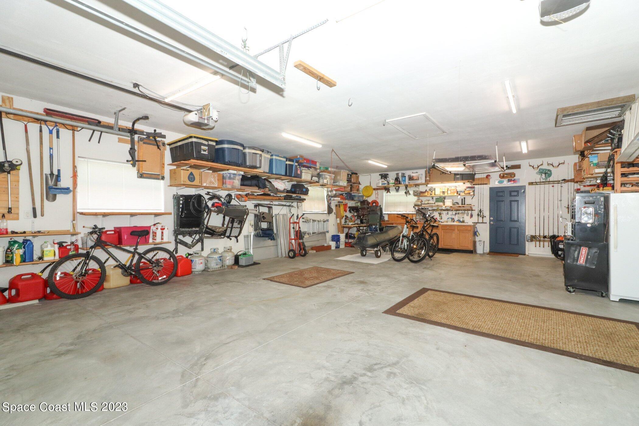 834 Egret Road Cocoa, FL 32926 - Photo 38 of 85 a view of a garage with rack and bicycle