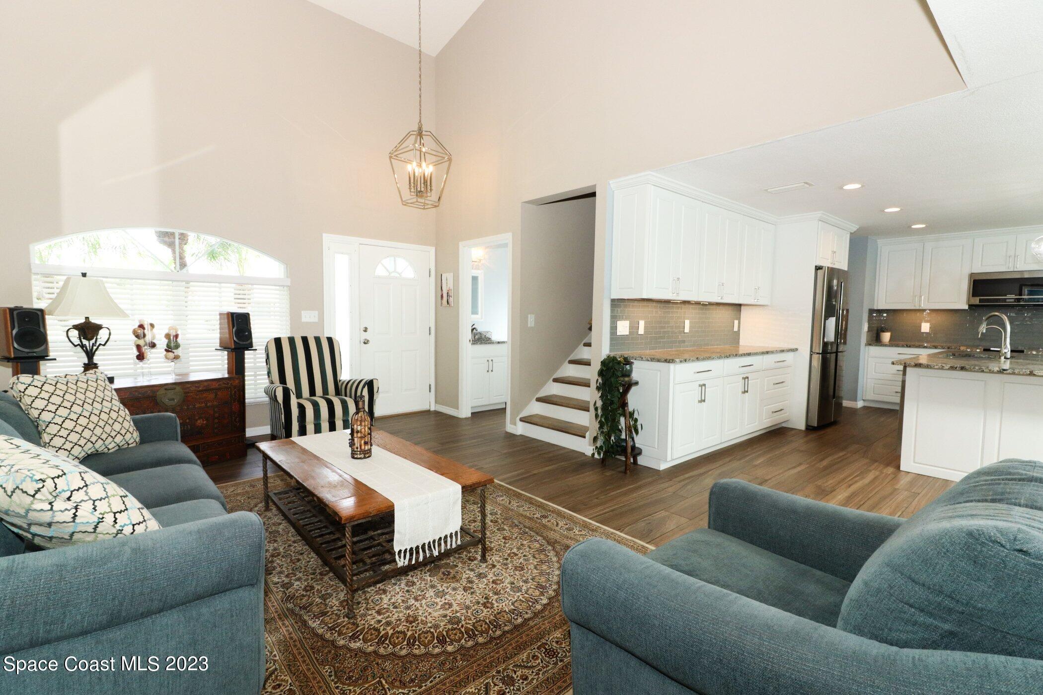834 Egret Road Cocoa, FL 32926 - Photo 4 of 85 a living room with furniture kitchen view and a chandelier