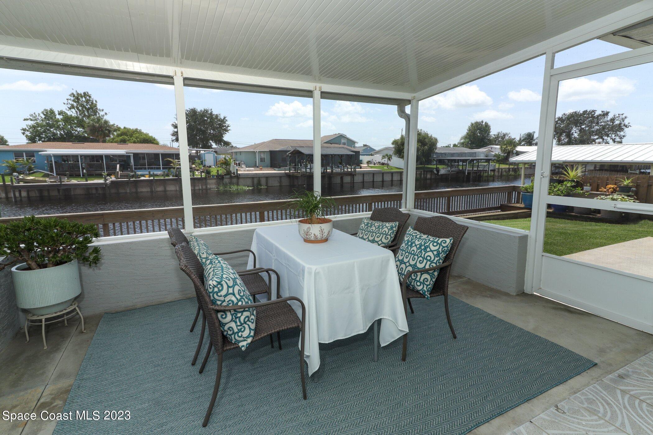 834 Egret Road Cocoa, FL 32926 - Photo 43 of 85 a dining room with furniture and a floor to ceiling window