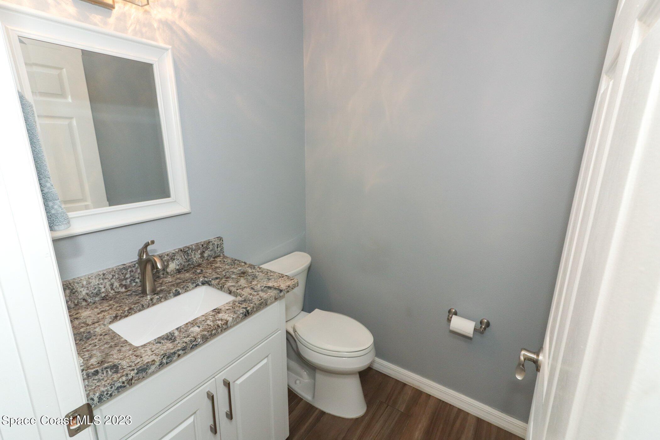 834 Egret Road Cocoa, FL 32926 - Photo 5 of 85 a bathroom with a granite countertop sink and a mirror