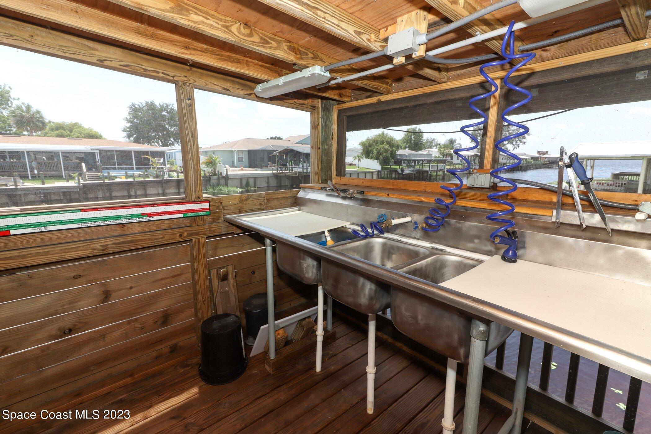 834 Egret Road Cocoa, FL 32926 - Photo 51 of 85 a view of a balcony with chairs and wooden floor