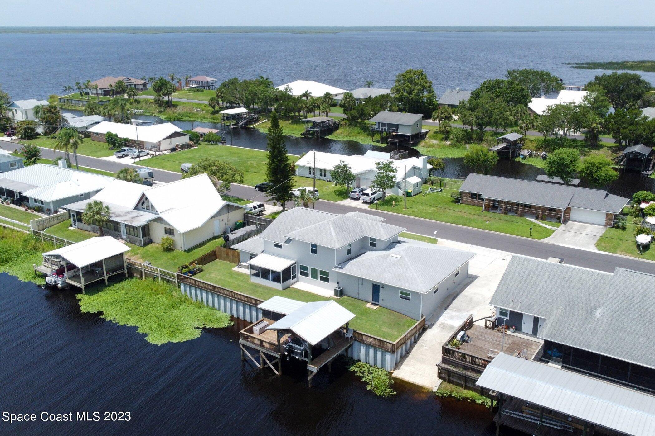 834 Egret Road Cocoa, FL 32926 - Photo 60 of 85 an aerial view of a house with a swimming pool patio and outdoor seating