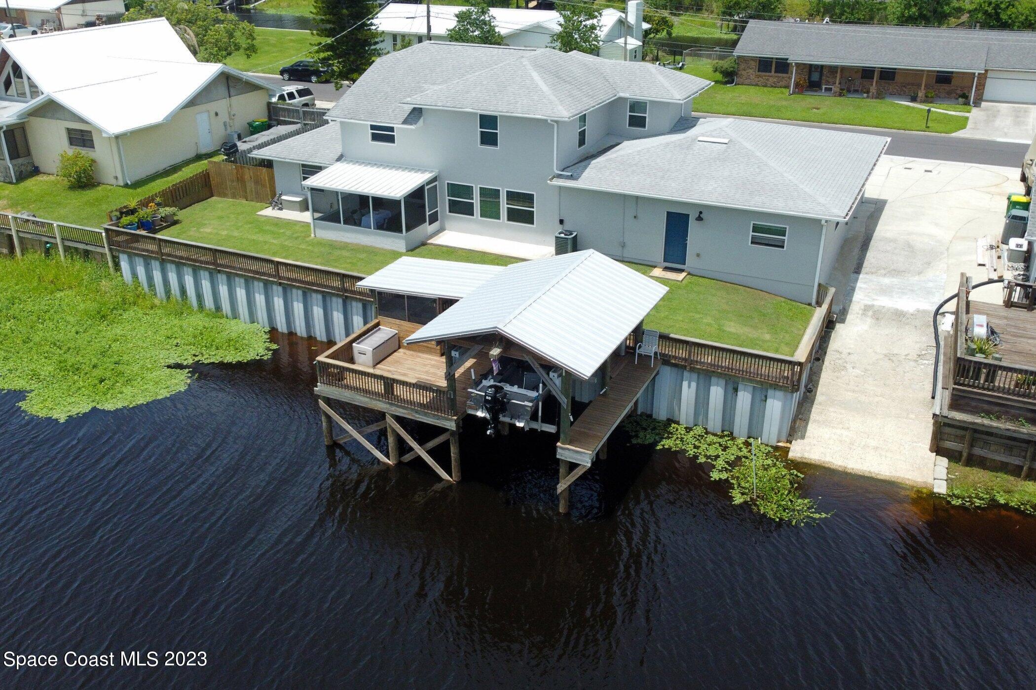 834 Egret Road Cocoa, FL 32926 - Photo 62 of 85 an aerial view of a house with pool patio and outdoor seating