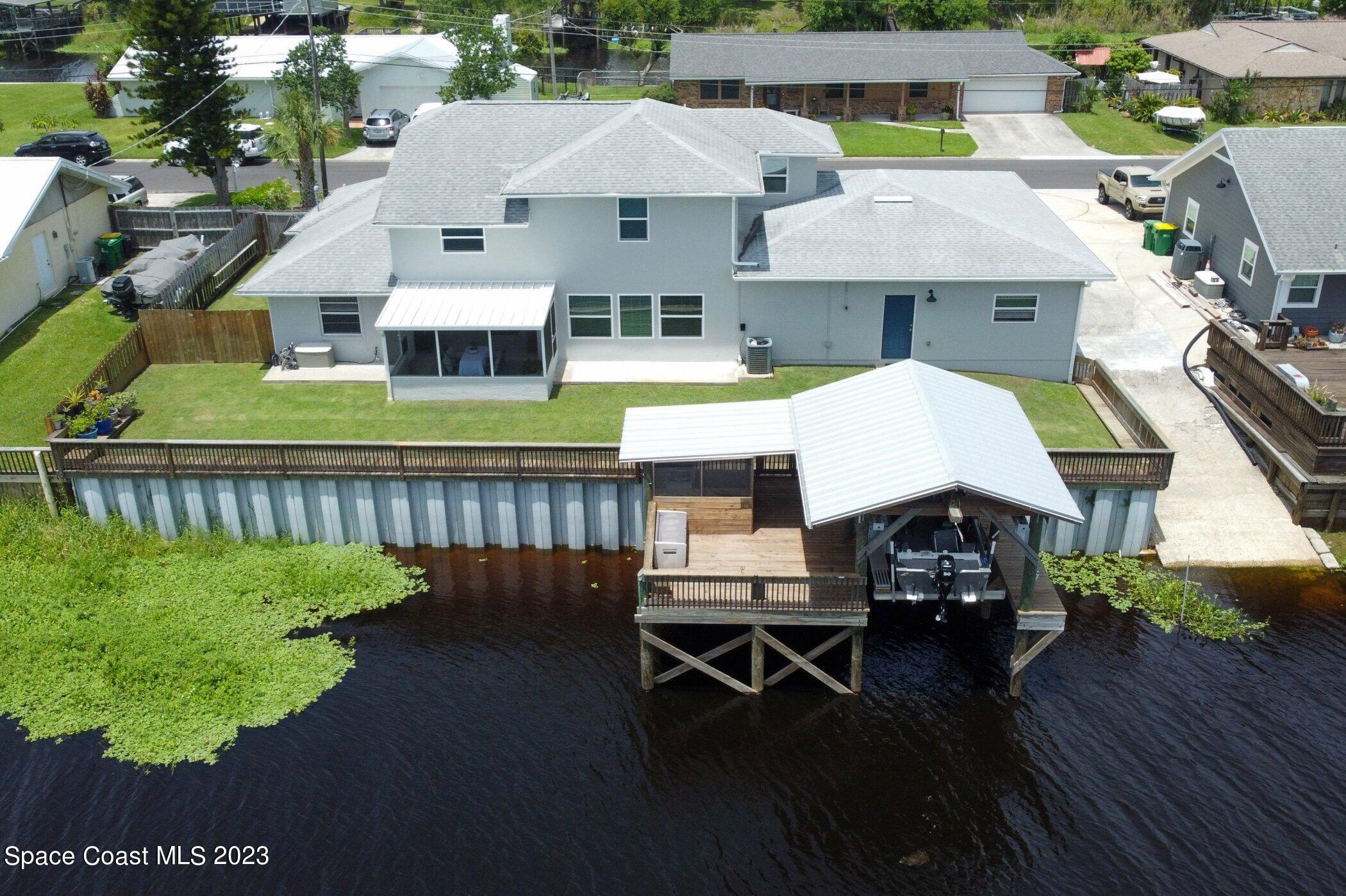 834 Egret Road Cocoa, FL 32926 - Photo 64 of 85 a aerial view of a house with swimming pool and sitting area