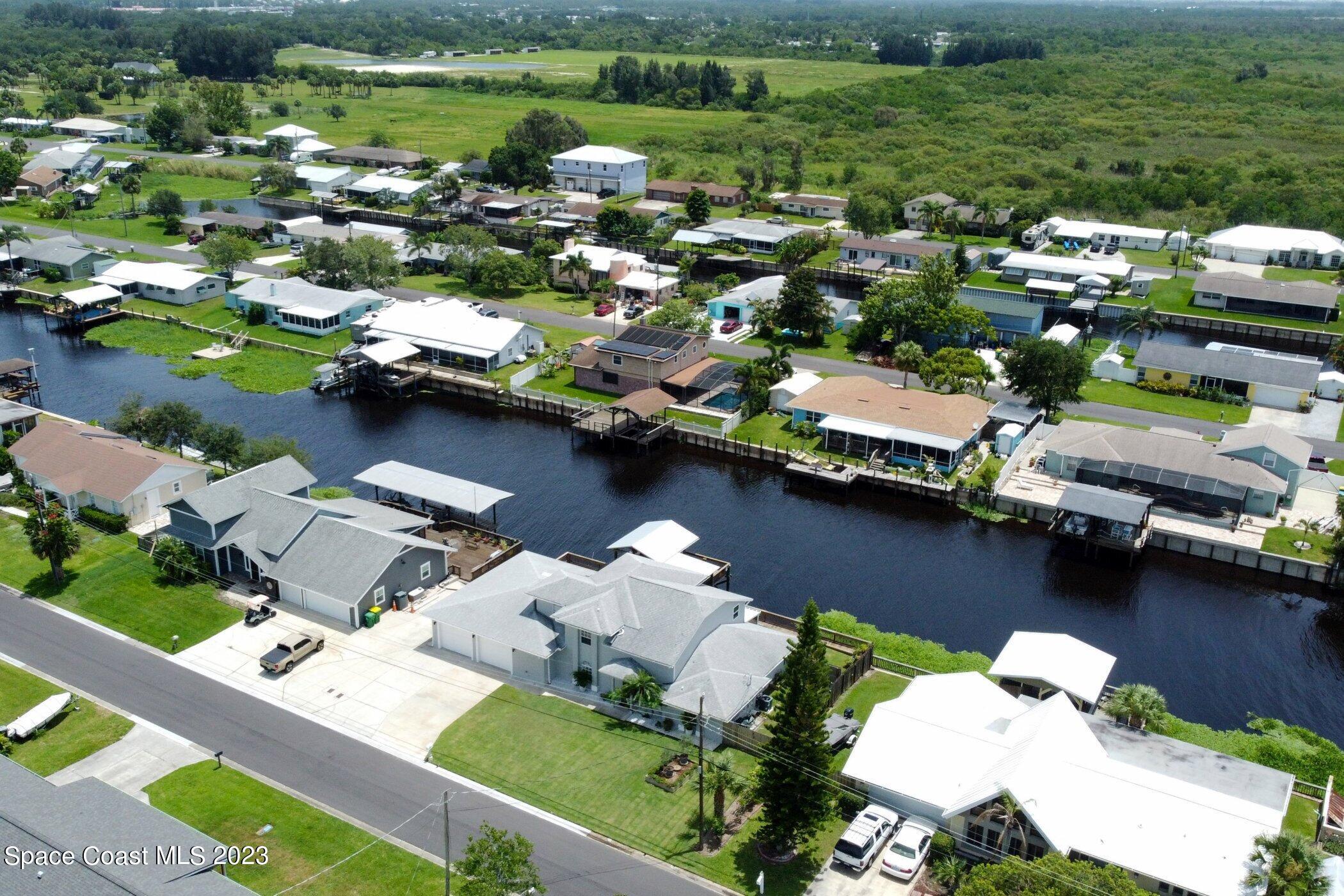 834 Egret Road Cocoa, FL 32926 - Photo 79 of 85 an aerial view of a house with a lake view