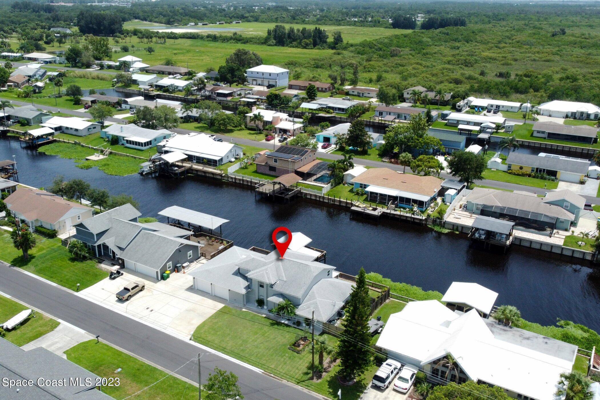 834 Egret Road Cocoa, FL 32926 - Photo 80 of 85 an aerial view of a house with a lake view