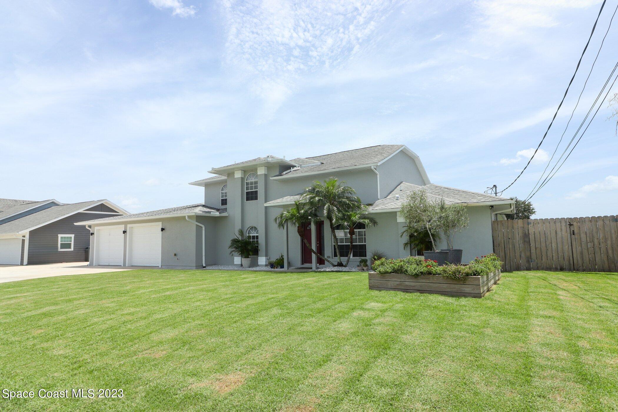834 Egret Road Cocoa, FL 32926 - Photo 85 of 85 a view of a house with a big yard and large trees