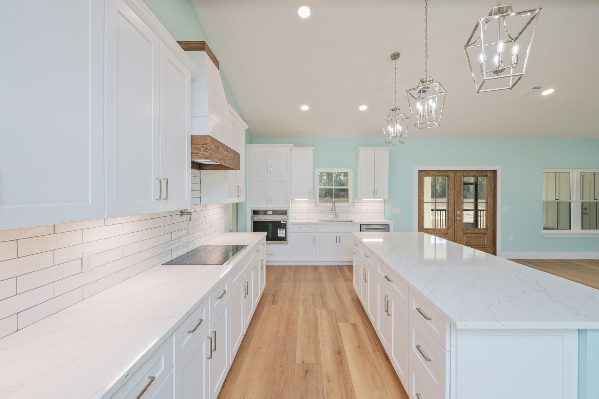 3504 Plympton Road Laurel Hill, FL 32567 - Photo 17 of 62 a large white kitchen with a large window a sink and dishwasher