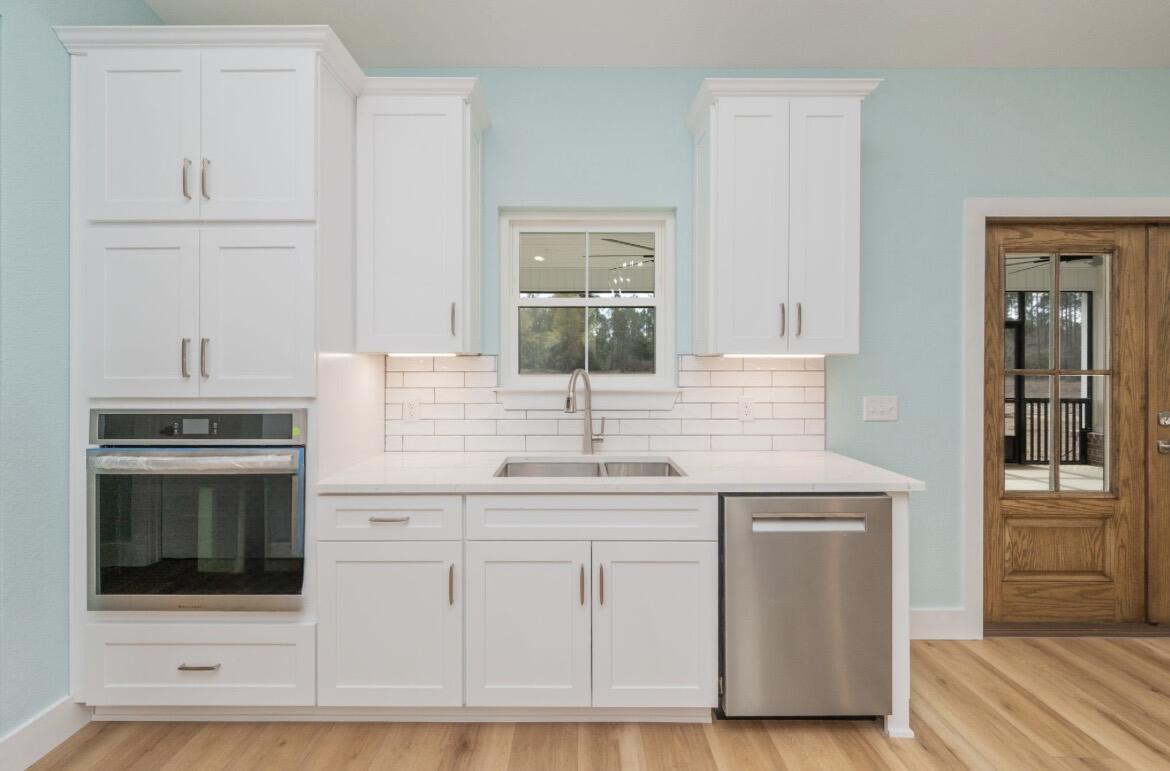 3504 Plympton Road Laurel Hill, FL 32567 - Photo 18 of 62 a kitchen with white cabinets and sink
