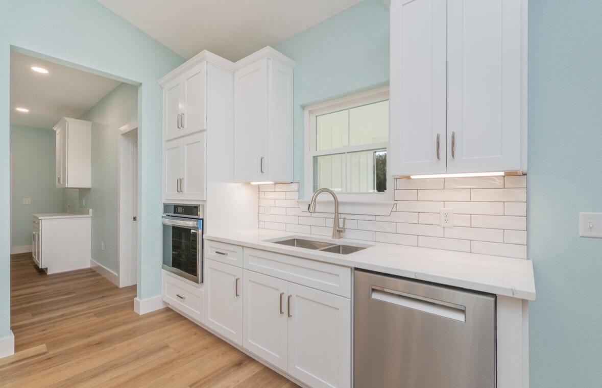 3504 Plympton Road Laurel Hill, FL 32567 - Photo 19 of 62 a kitchen with stainless steel appliances granite countertop a sink and dishwasher with white cabinets