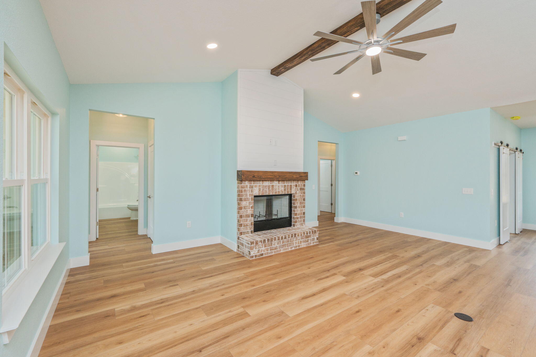 3504 Plympton Road Laurel Hill, FL 32567 - Photo 23 of 62 a view of an empty room with wooden floor fireplace and a window