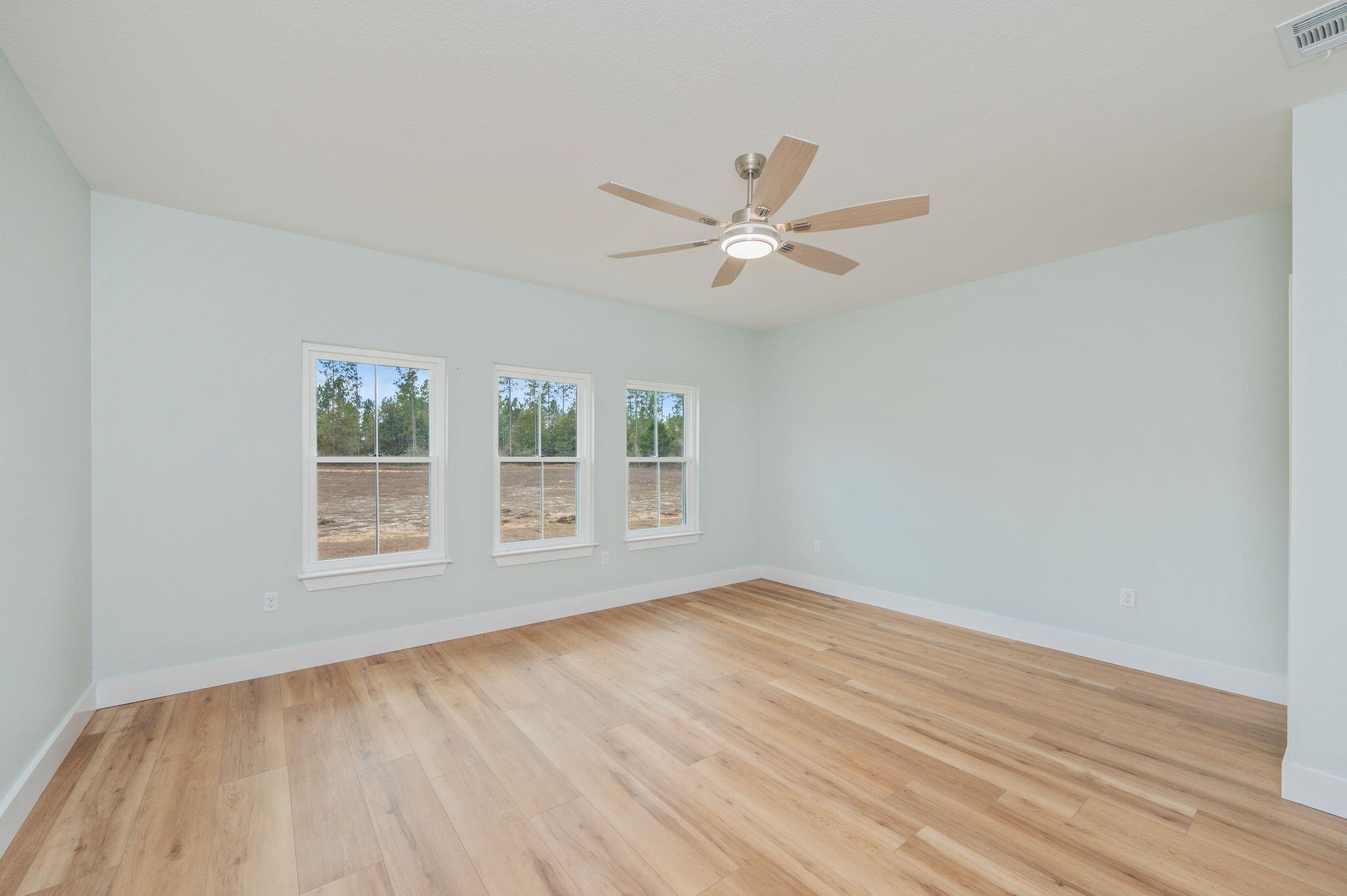 3504 Plympton Road Laurel Hill, FL 32567 - Photo 25 of 62 a view of an empty room with a window and wooden floor