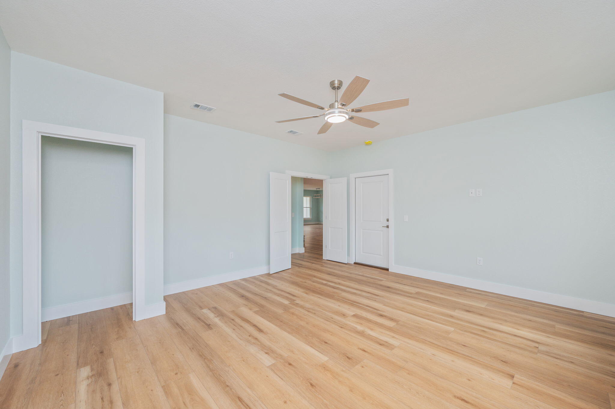 3504 Plympton Road Laurel Hill, FL 32567 - Photo 26 of 62 a big room with wooden floor and a ceiling fan