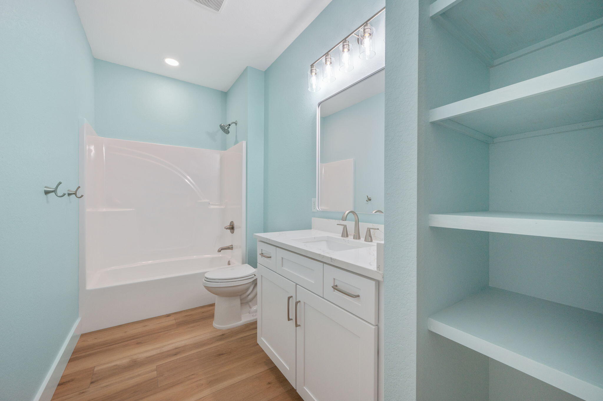 3504 Plympton Road Laurel Hill, FL 32567 - Photo 28 of 62 a bathroom with a granite countertop toilet a sink and a bathtub