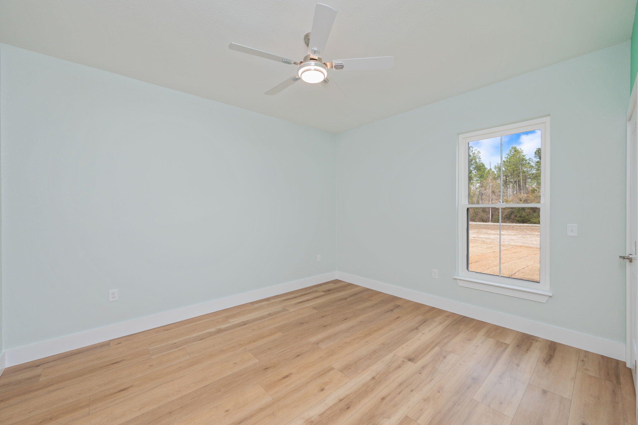 3504 Plympton Road Laurel Hill, FL 32567 - Photo 34 of 62 an empty room with wooden floor and windows