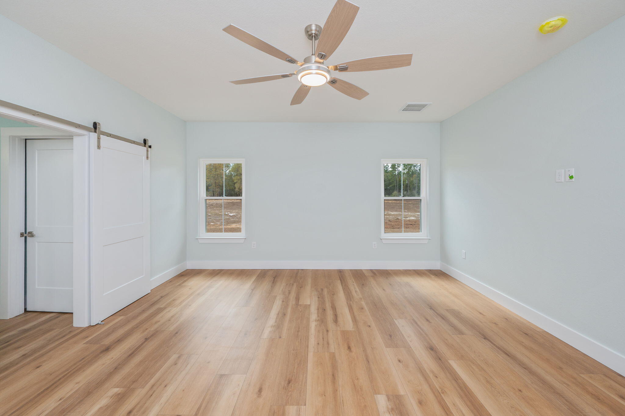 3504 Plympton Road Laurel Hill, FL 32567 - Photo 40 of 62 a view of an empty room with wooden floor and a window