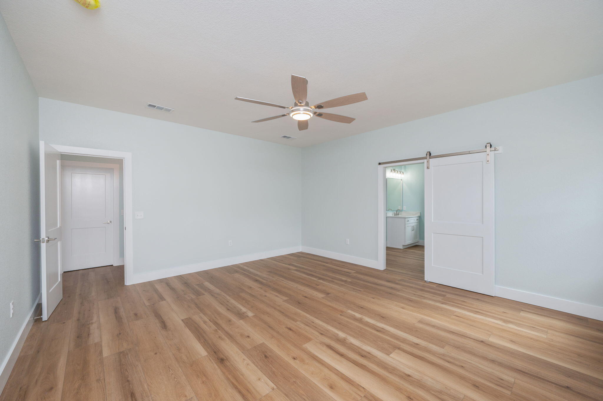 3504 Plympton Road Laurel Hill, FL 32567 - Photo 41 of 62 an empty room with wooden floor and a ceiling fan