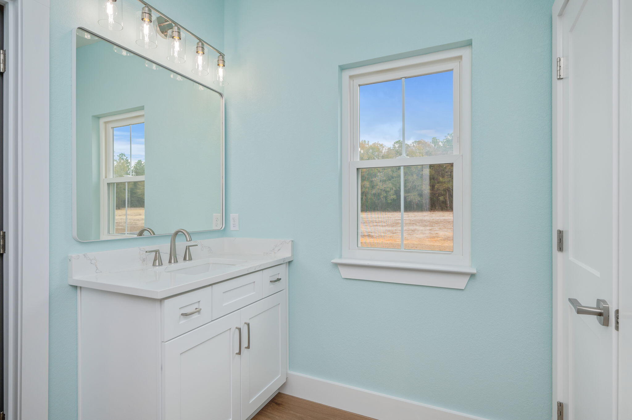 3504 Plympton Road Laurel Hill, FL 32567 - Photo 43 of 62 a bathroom with a sink a vanity and a mirror
