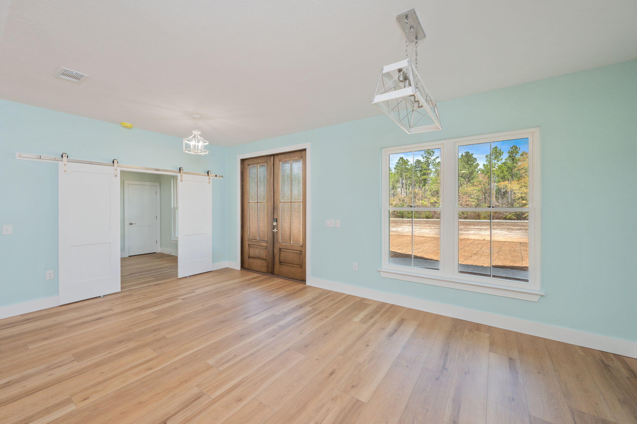 3504 Plympton Road Laurel Hill, FL 32567 - Photo 10 of 62 a view of an empty room with wooden floor and a window