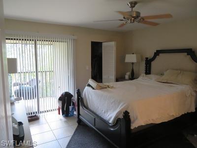 3806 Guilford Road, Unit 101 Naples, FL 34112 - Photo 11 of 19 a bedroom with a bed and a chandelier