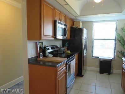 3806 Guilford Road, Unit 101 Naples, FL 34112 - Photo 7 of 19 a kitchen with stainless steel appliances granite countertop a stove a sink and a refrigerator