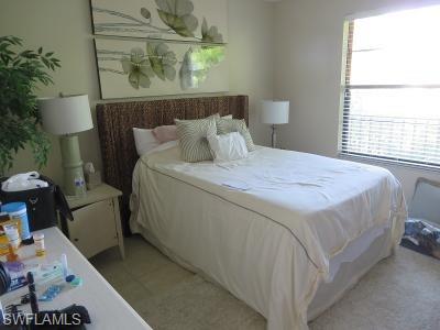 3806 Guilford Road, Unit 101 Naples, FL 34112 - Photo 9 of 19 a bed sitting in a bedroom next to a window