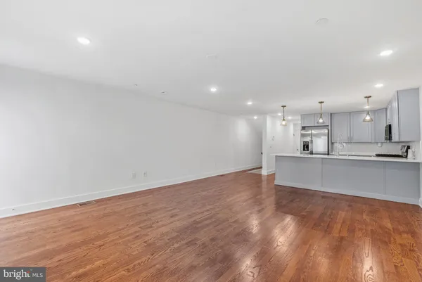 a view of kitchen with kitchen island microwave and stove