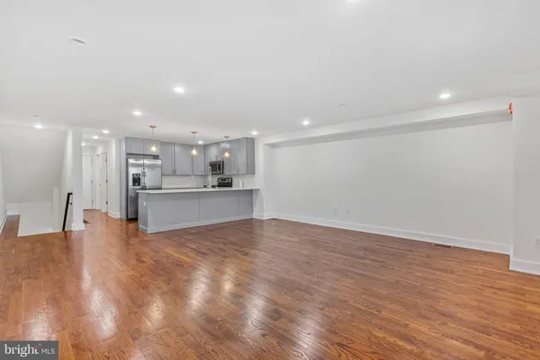 a view of kitchen with kitchen island and stainless steel appliances