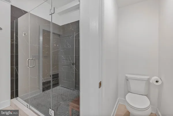 a bathroom with a shower a toilet and sink