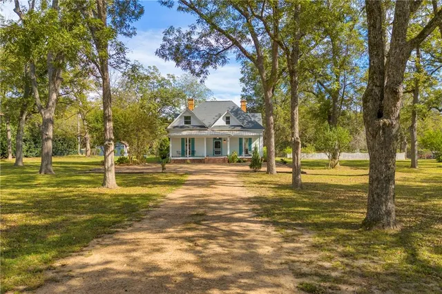 a house with swimming pool in front of it