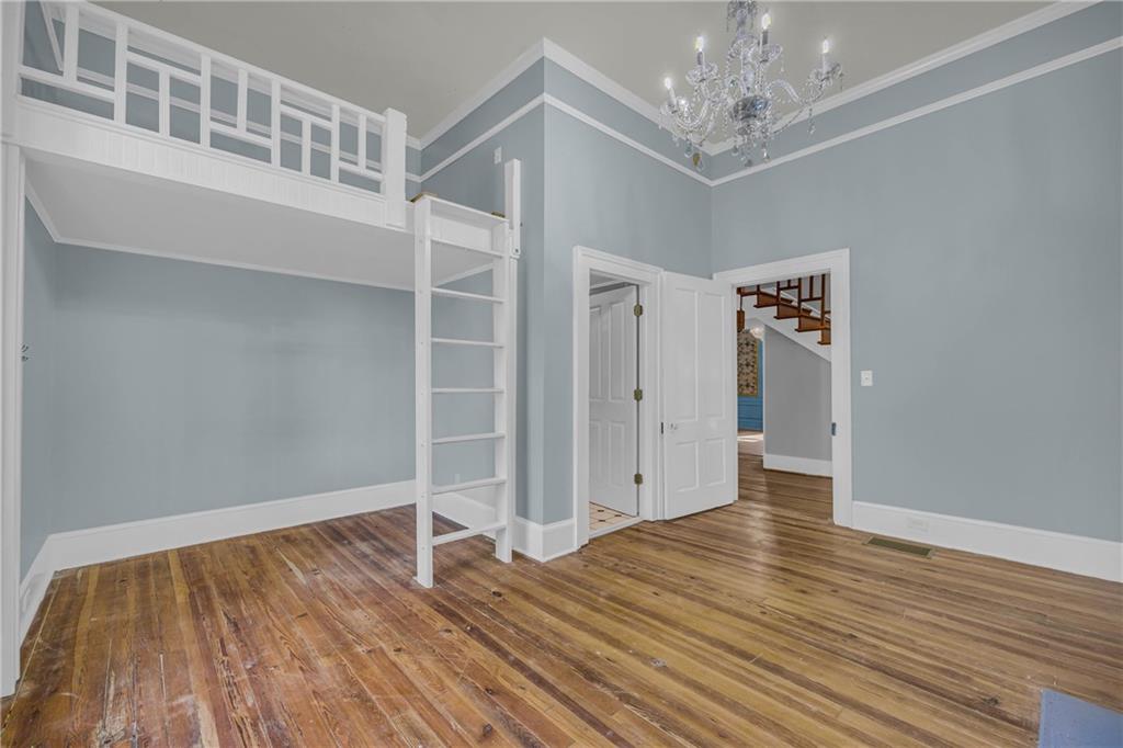 5921 Bostwick Road Bishop, GA 30621 - Photo 13 of 65 a view of an empty room with wooden floor