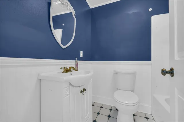 a bathroom with a sink a toilet and a mirror