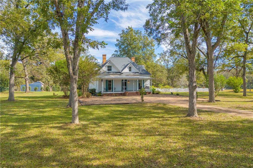 5921 Bostwick Road Bishop, GA 30621 - Photo 2 of 65 a front view of a house with a yard