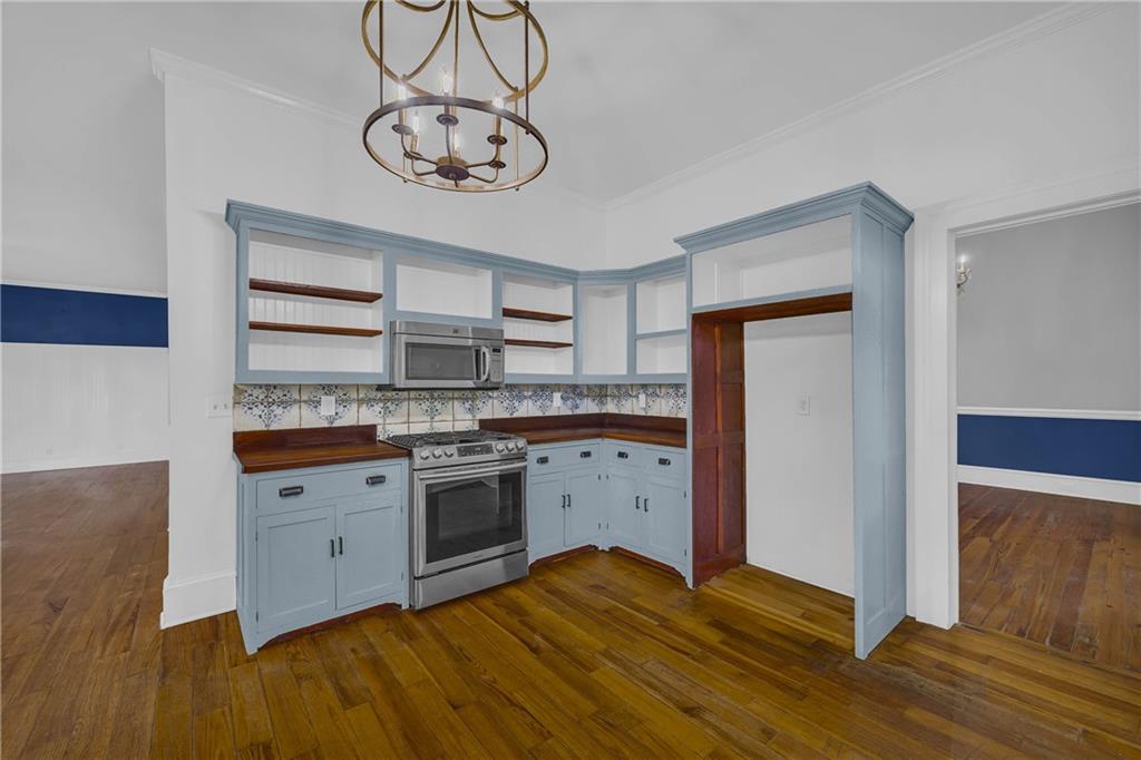 5921 Bostwick Road Bishop, GA 30621 - Photo 21 of 65 a kitchen with stainless steel appliances granite countertop a stove cabinets and wooden floor