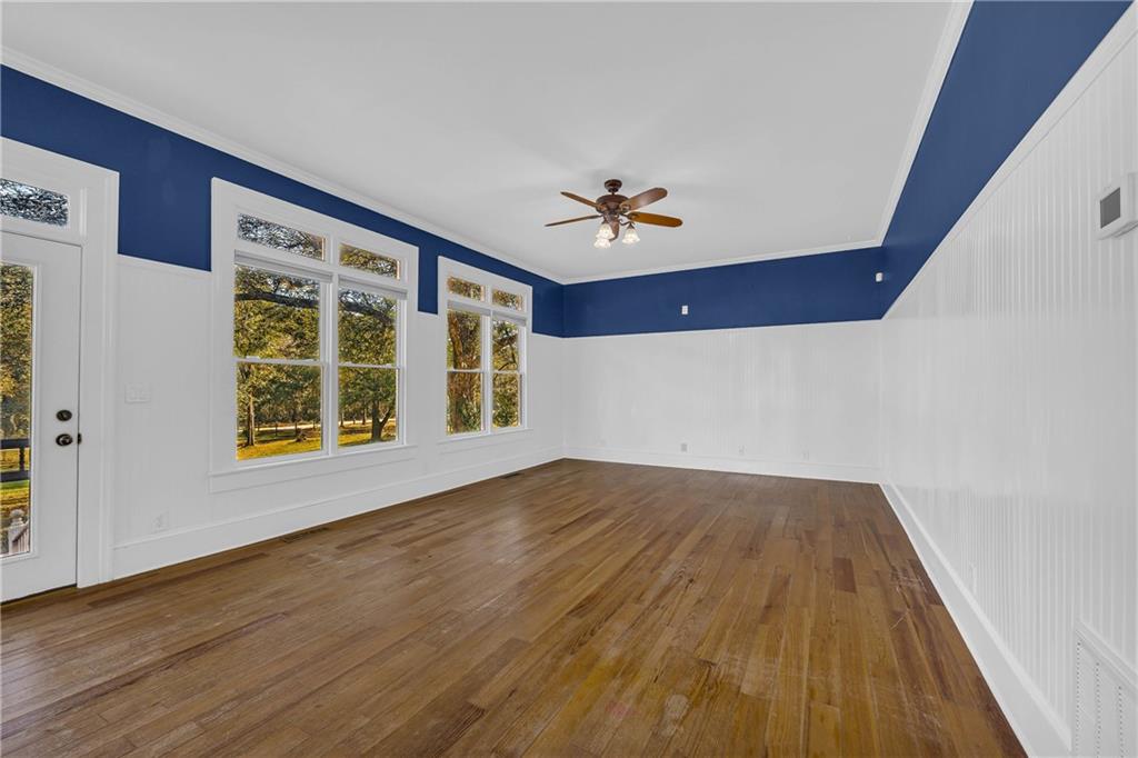 5921 Bostwick Road Bishop, GA 30621 - Photo 25 of 65 a view of an empty room with a window and wooden floor