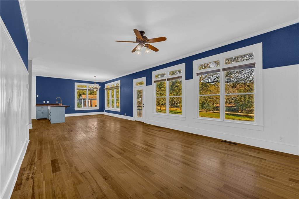 5921 Bostwick Road Bishop, GA 30621 - Photo 27 of 65 a view of an empty room with a window and wooden floor