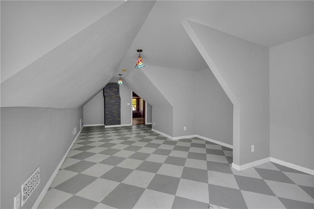 5921 Bostwick Road Bishop, GA 30621 - Photo 41 of 65 a view of an empty room with a black and white checkered floor